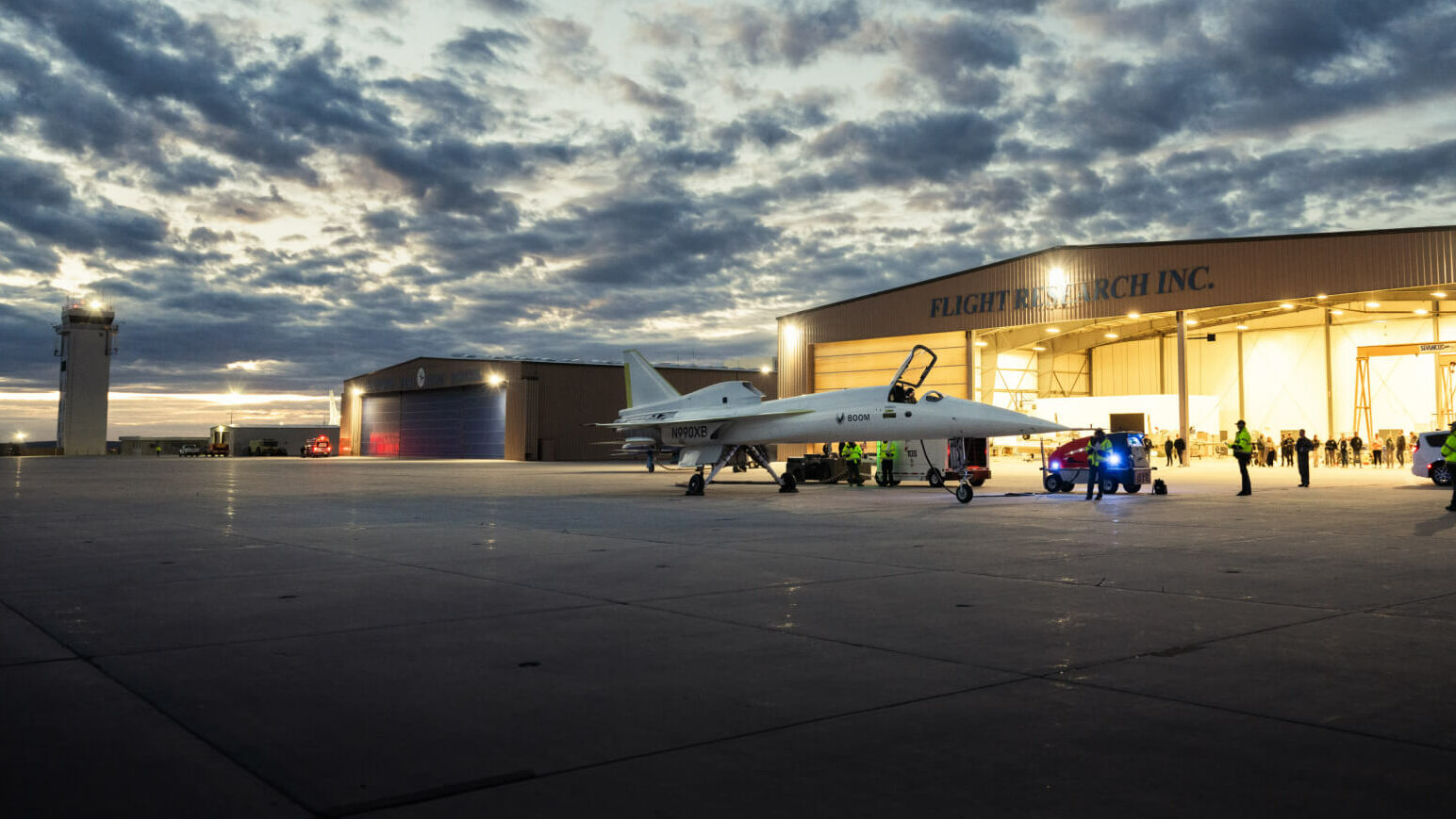 This image shows the hangar and Mojave tower at the Mojave Air & Space Port with XB-1, Boom's supersonic demonstrator in front of the hangar.